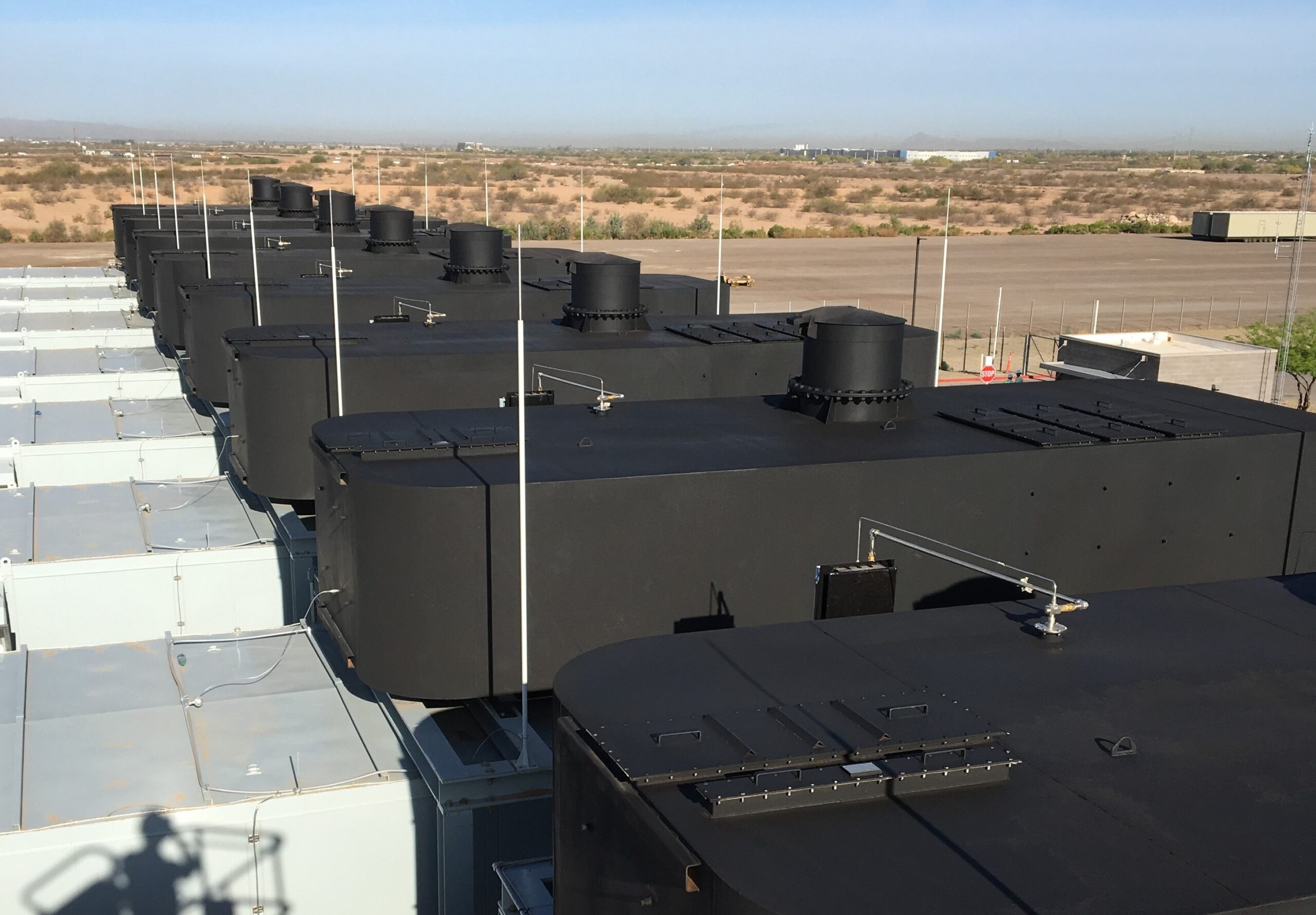 Row of MIRA-CUBE™ SCR/DPF systems installed on generator enclosures at a large data centre facility