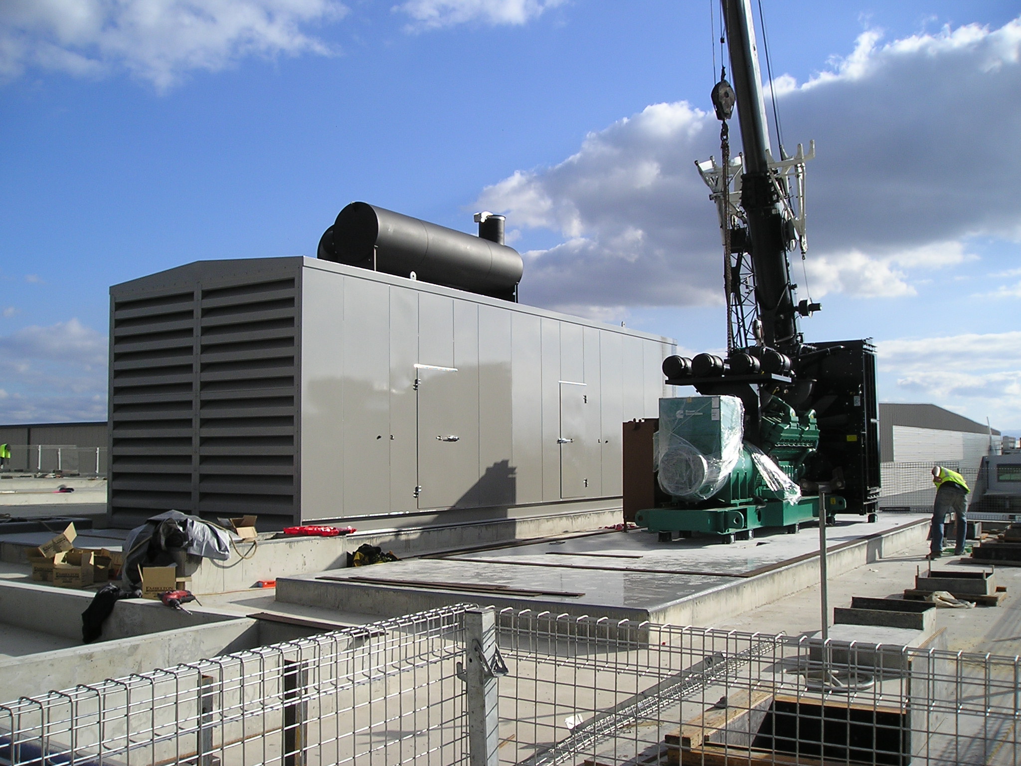 Packaged generator and exhaust equipment being installed by crane